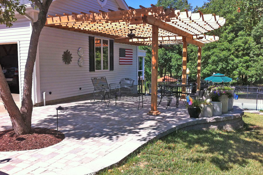 Esempio di un patio o portico chic di medie dimensioni e nel cortile laterale con pavimentazioni in mattoni e una pergola