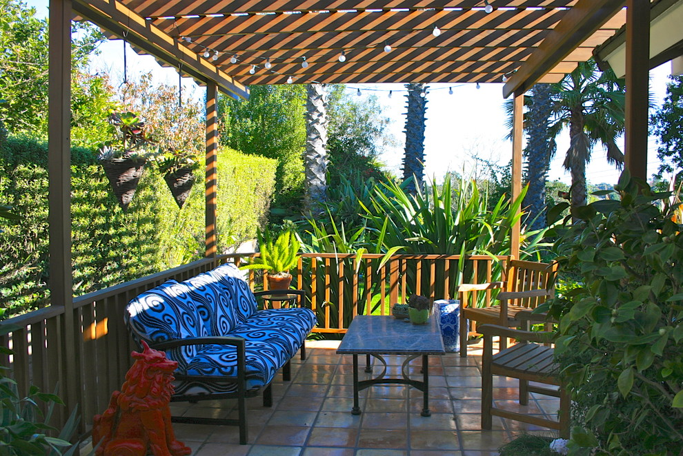 Design ideas for a large traditional back patio in Los Angeles with tiled flooring and a pergola.