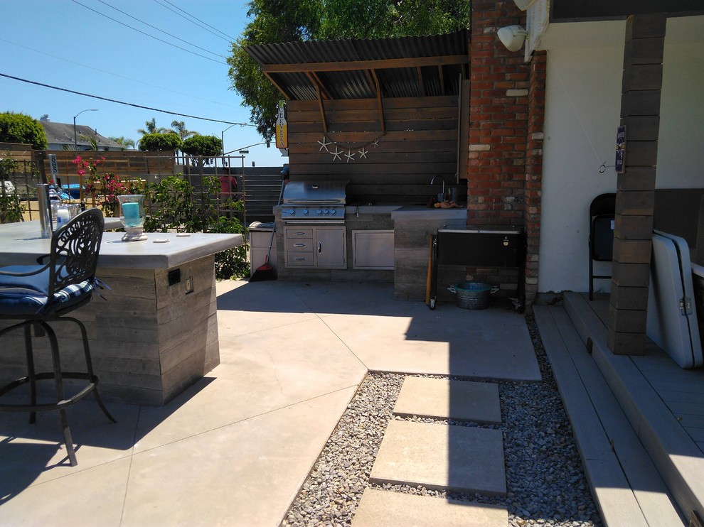 Beach style back patio in Orange County with natural stone paving.