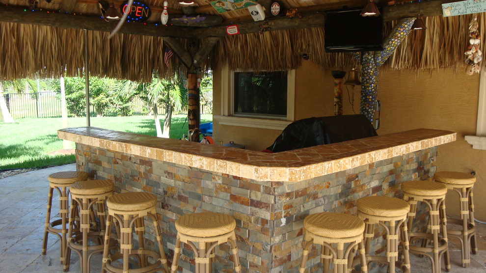Inspiration for a mid-sized tropical backyard patio kitchen remodel in Miami with a gazebo