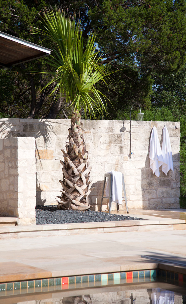 Photo of a world-inspired patio in Austin with an outdoor shower and no cover.