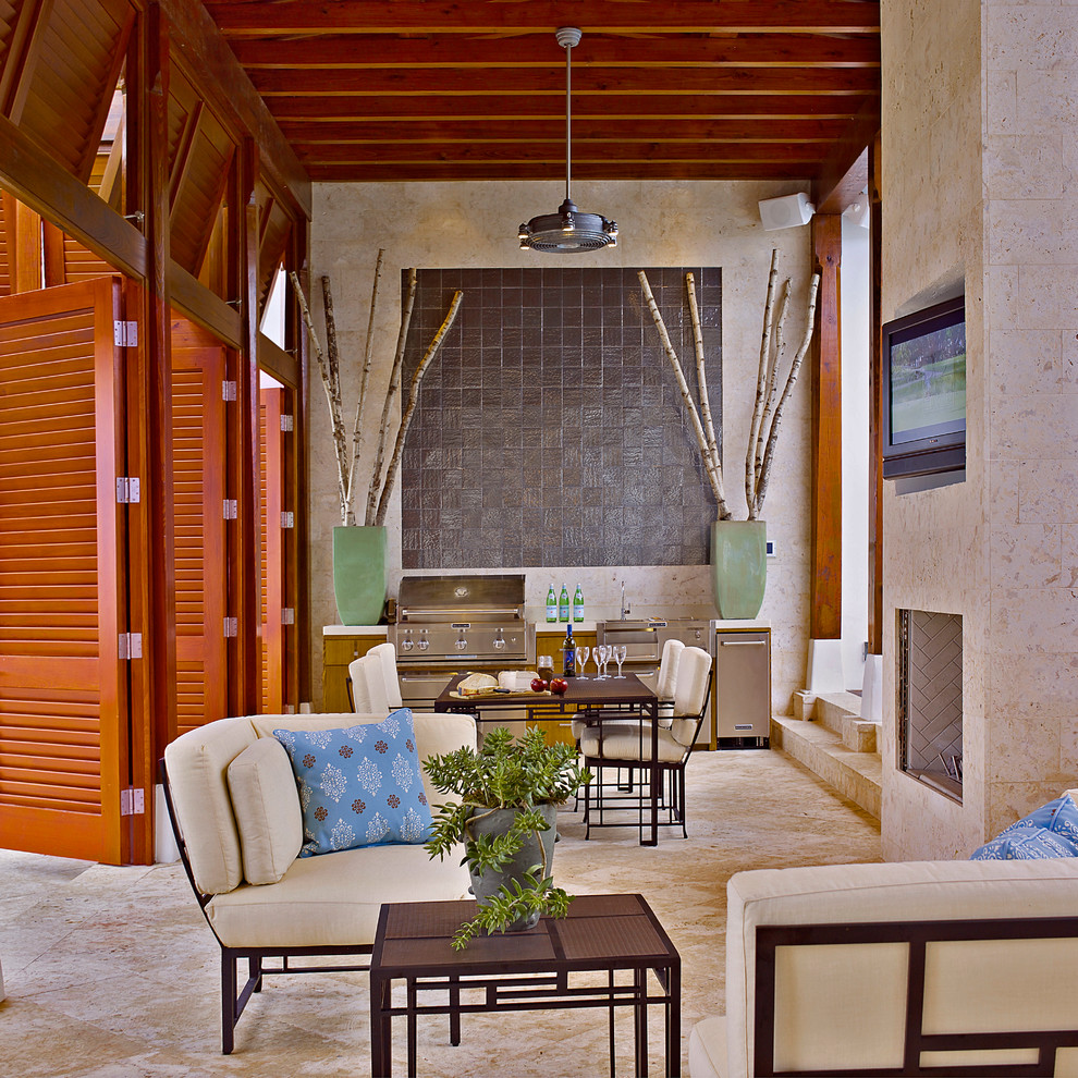 Inspiration for a world-inspired patio in Orlando with an outdoor kitchen, tiled flooring and a roof extension.