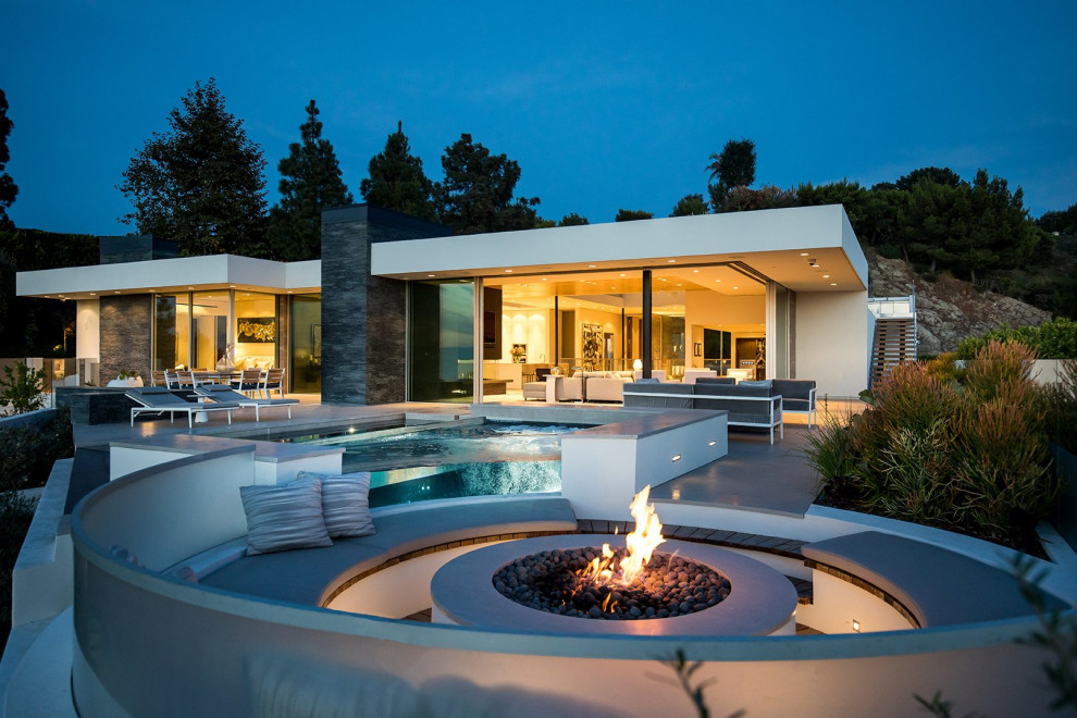 Example of a trendy patio design in Sacramento with a fire pit and no cover