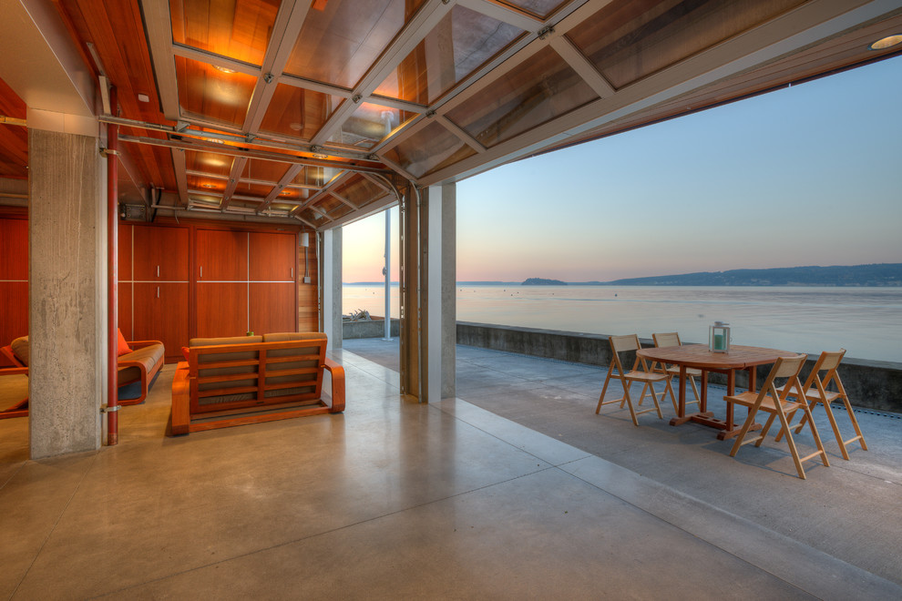Photo of a small contemporary back patio in Seattle with concrete slabs, an outdoor kitchen and a roof extension.