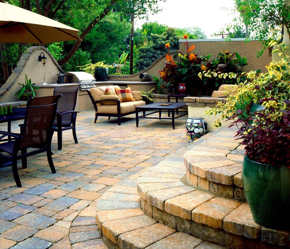 Inspiration for a mid-sized mediterranean stone patio remodel in Los Angeles with no cover