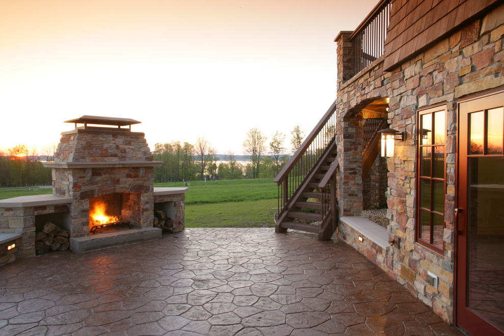 Design ideas for a medium sized rustic back patio in Other with a fire feature, stamped concrete and no cover.