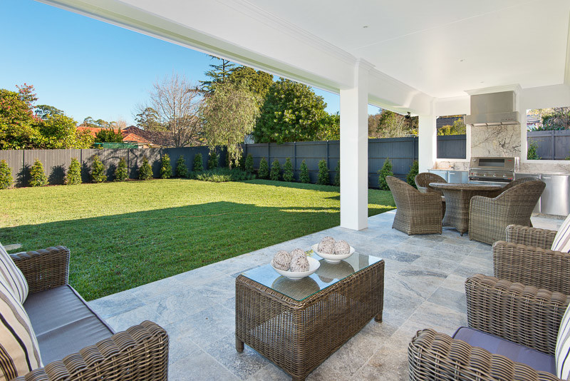 This is an example of a contemporary back patio in Sydney with an outdoor kitchen, tiled flooring and a roof extension.