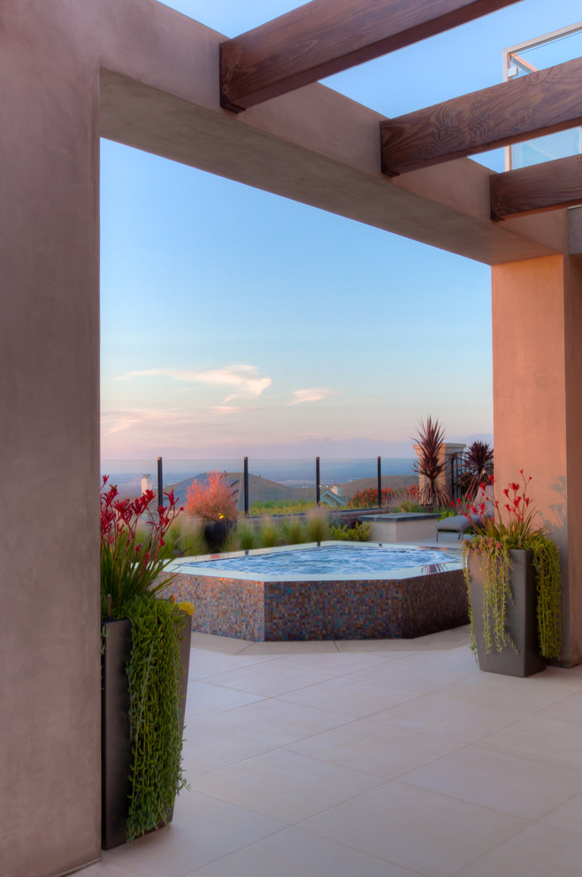 Mid-sized trendy backyard tile patio photo in Orange County with a pergola