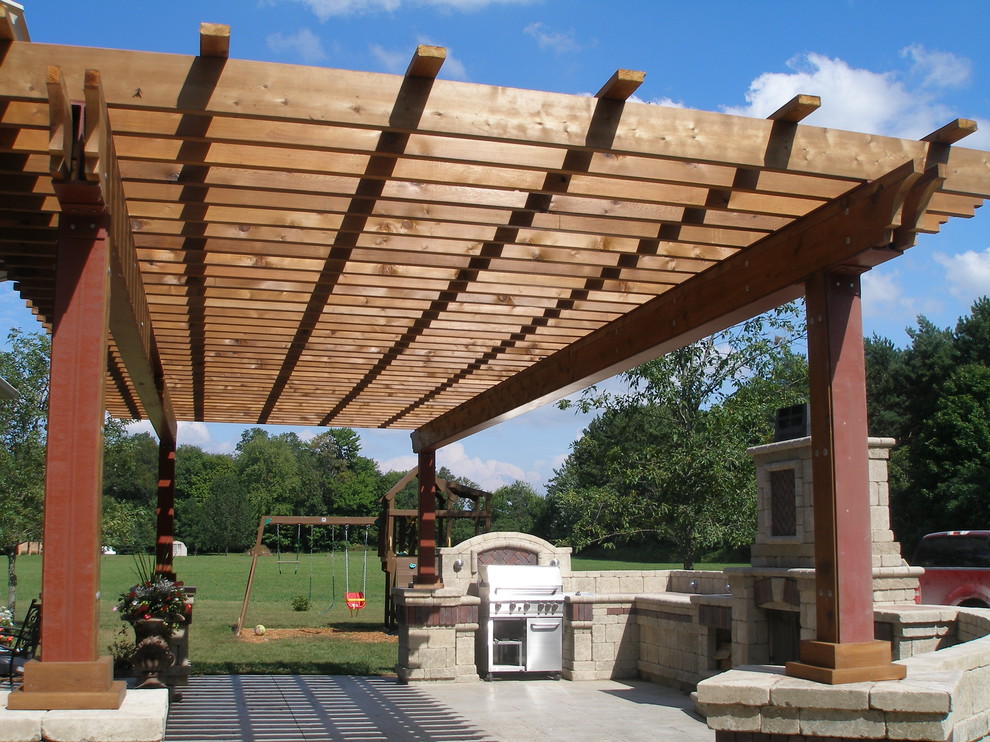 Large tuscan backyard stone patio photo in Toronto with a fire pit and a pergola