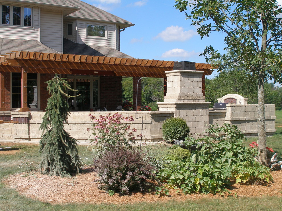 Example of a large tuscan backyard patio design in Toronto with a fire pit and a pergola