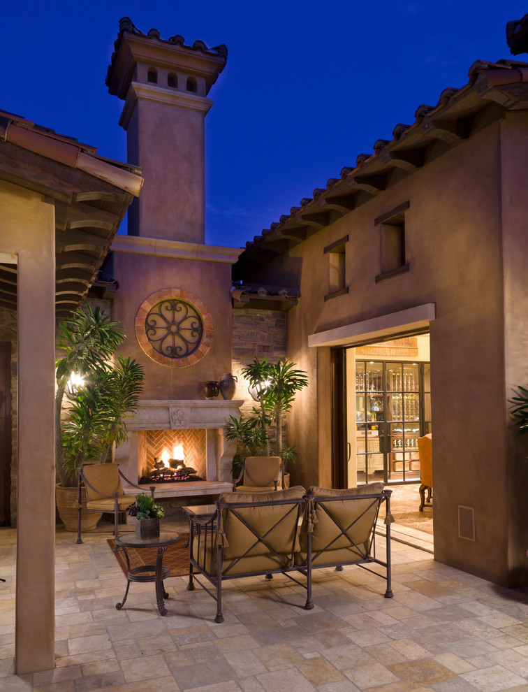Tuscan patio photo in Orange County with a fire pit and no cover