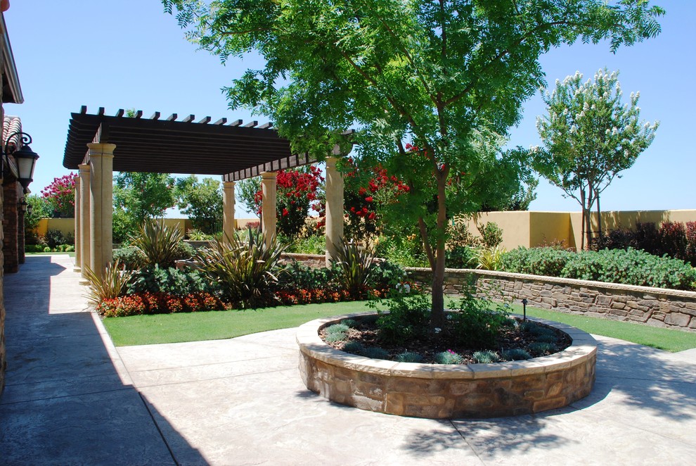Inspiration for a huge southwestern backyard concrete paver patio remodel in Other