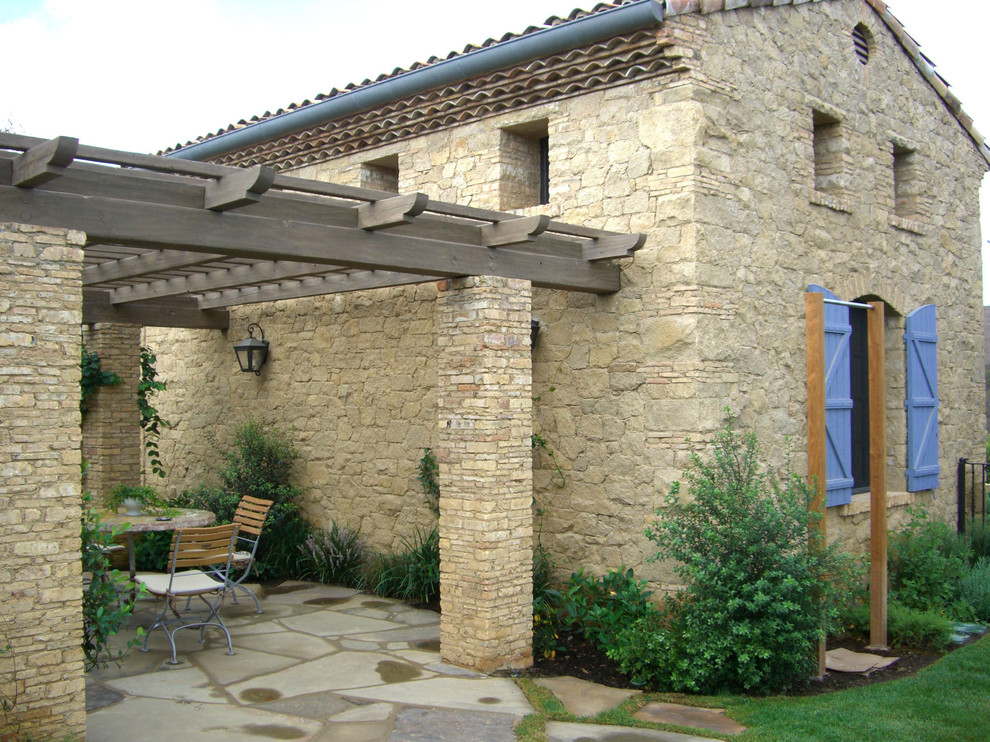 Mediterranean patio in Other with a pergola.
