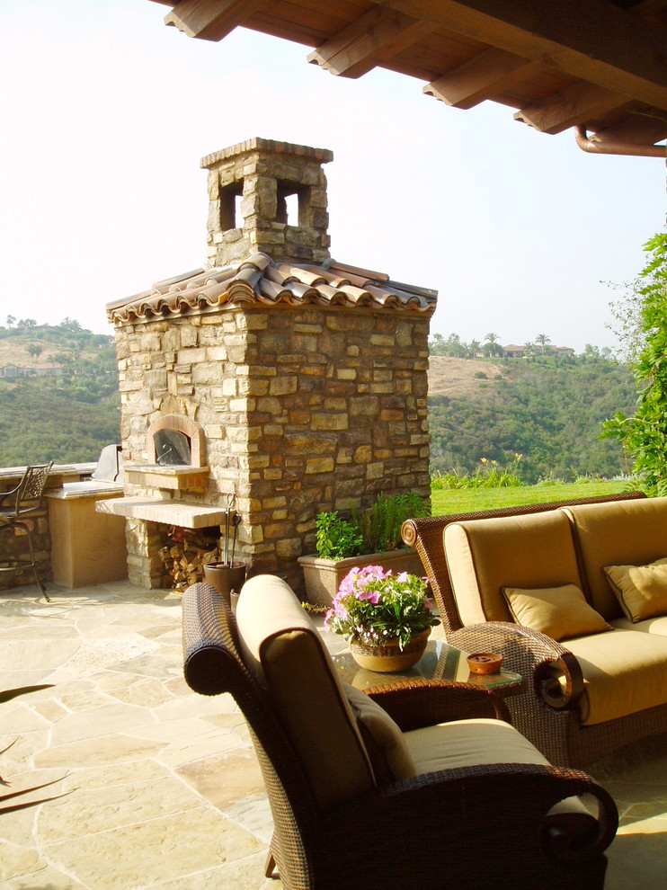 Huge tuscan courtyard stone patio fountain photo in San Diego with no cover