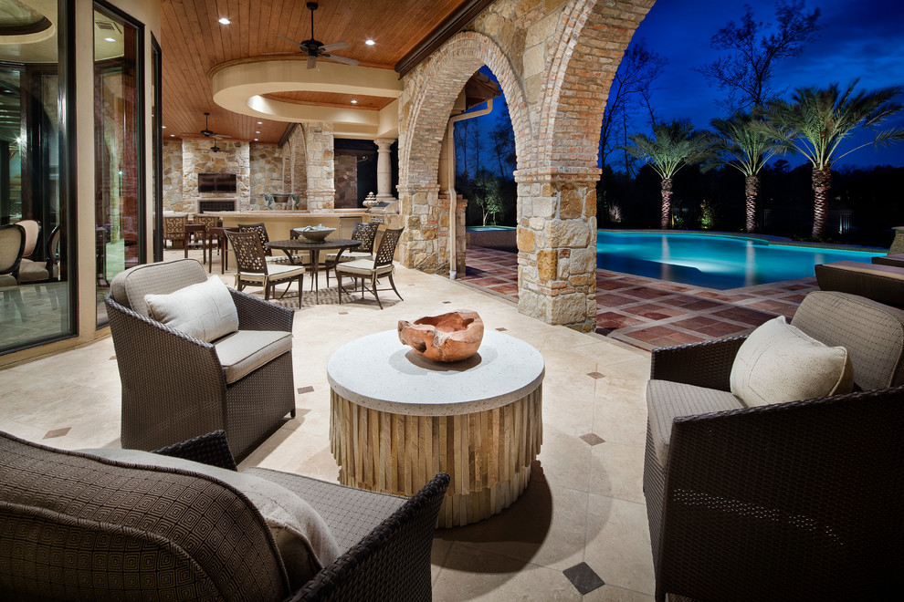 Inspiration for a mediterranean back patio in Houston with an outdoor kitchen and a roof extension.