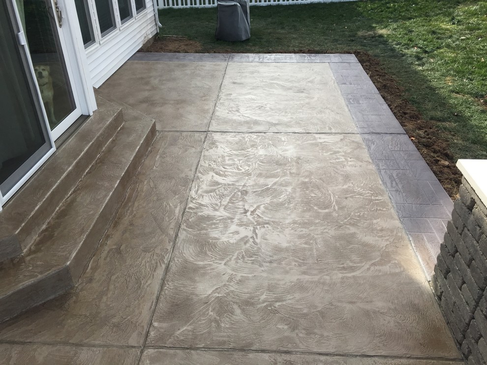Photo of a small mediterranean back patio in St Louis with stamped concrete.