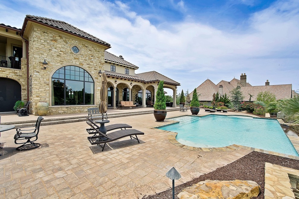 Example of a tuscan patio design in Dallas with no cover
