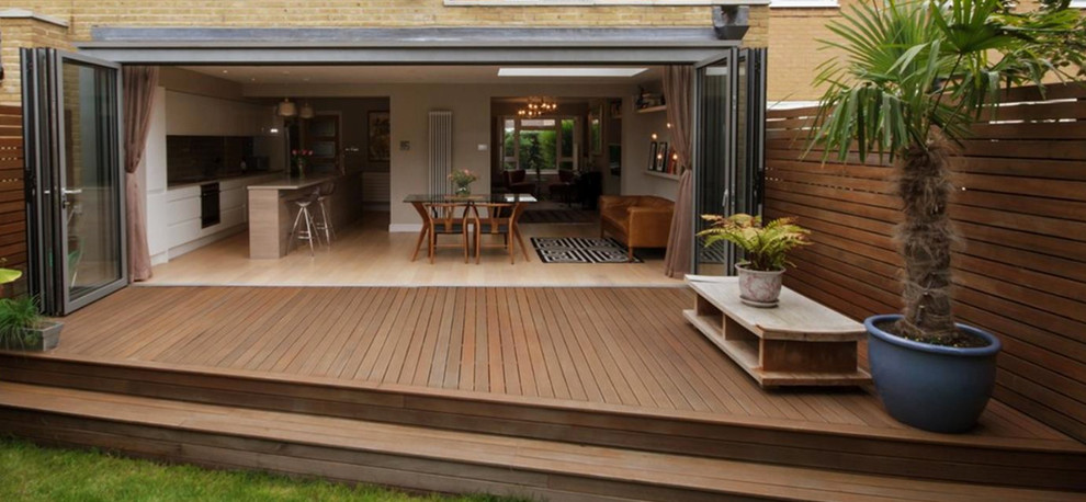 Example of a trendy backyard patio design in London with no cover
