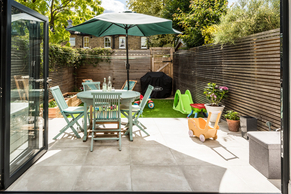 Patio - small contemporary backyard patio idea in London with no cover