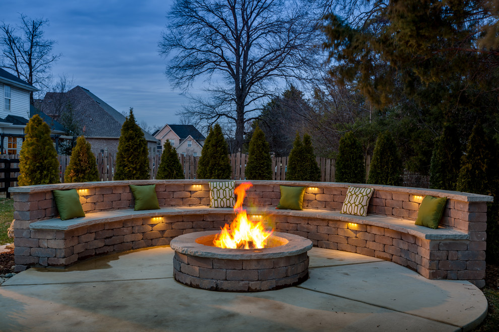 Inspiration for a traditional back patio in Nashville with a fire feature, concrete slabs and no cover.