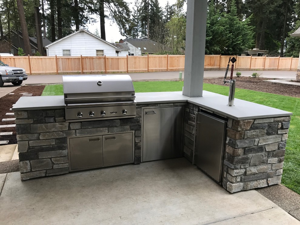 Example of a mid-sized classic backyard concrete patio kitchen design in Portland with a gazebo