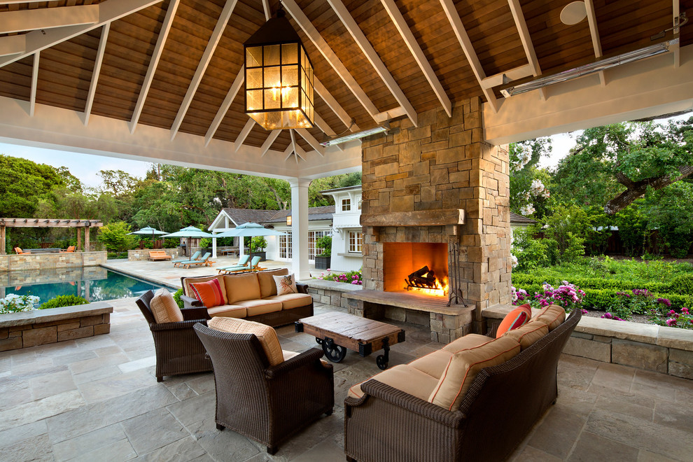 Example of a huge classic backyard tile patio design in San Francisco with a fire pit and a roof extension