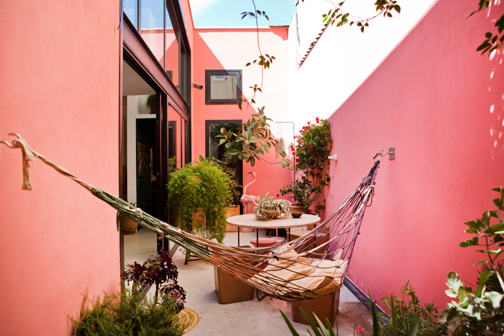 Unbedeckter Moderner Patio im Innenhof mit Kübelpflanzen und Betonplatten in Barcelona