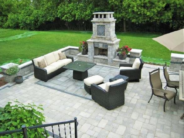 Mid-sized island style backyard brick patio photo in Chicago with a fireplace