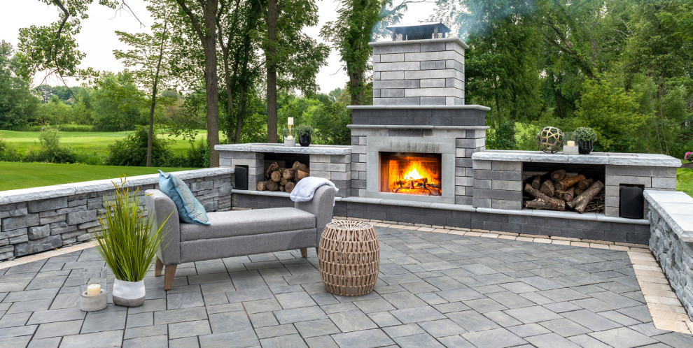 Inspiration for a contemporary backyard concrete paver patio remodel in New York with a fireplace