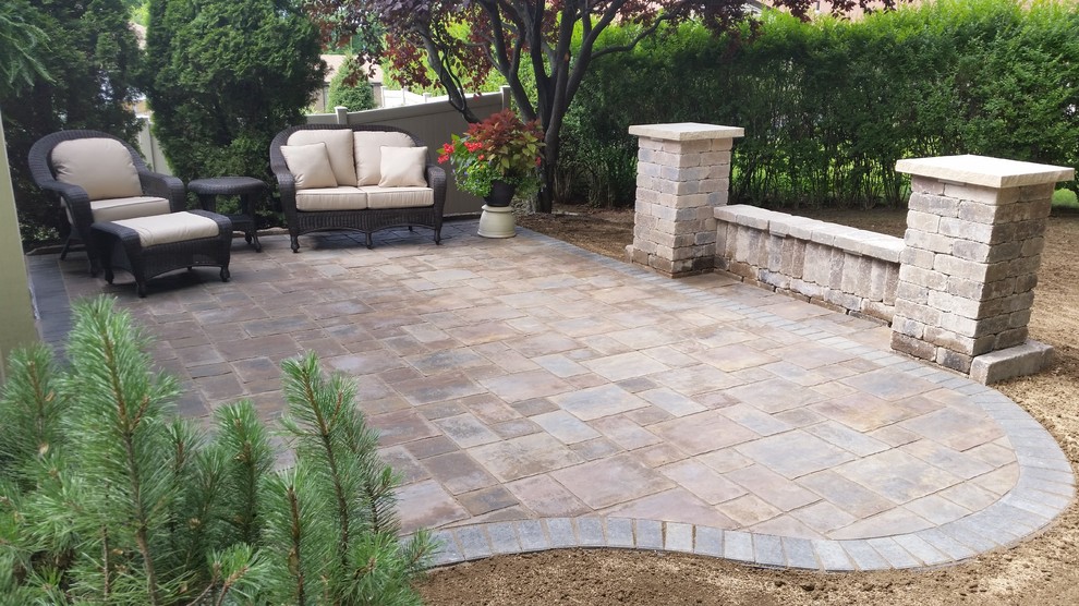 Example of a small classic backyard concrete paver patio design in Other with no cover