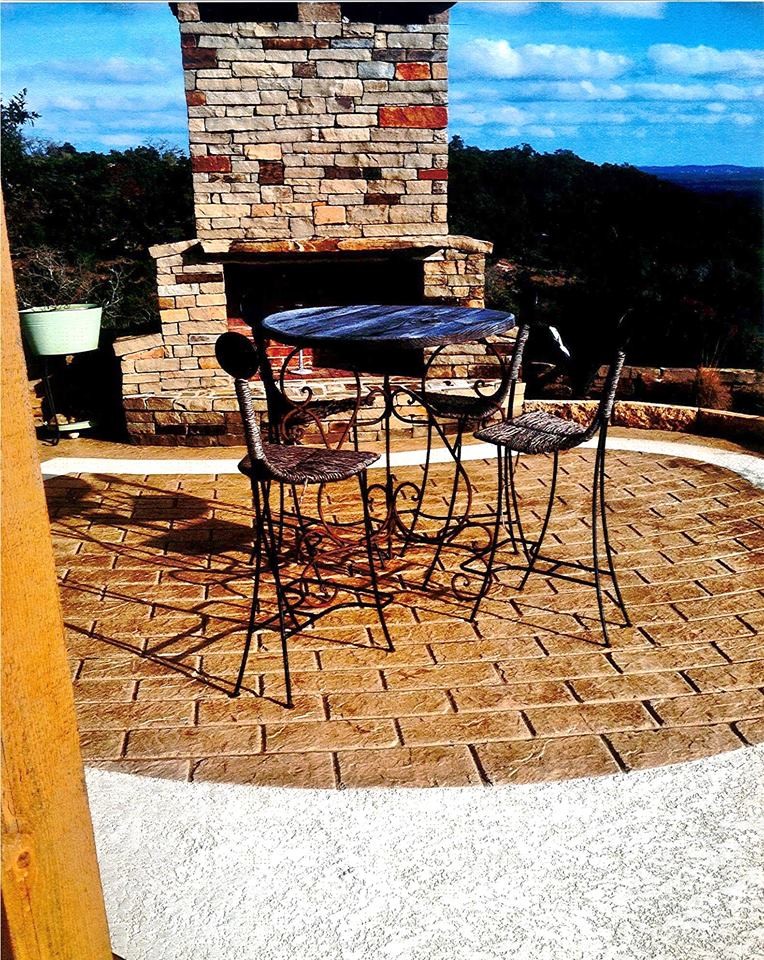 Photo of a small classic back patio in St Louis with a fire feature, concrete paving and no cover.