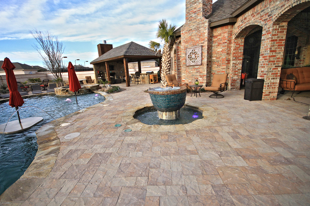 Medium sized world-inspired back patio in Dallas with a water feature, concrete paving and no cover.
