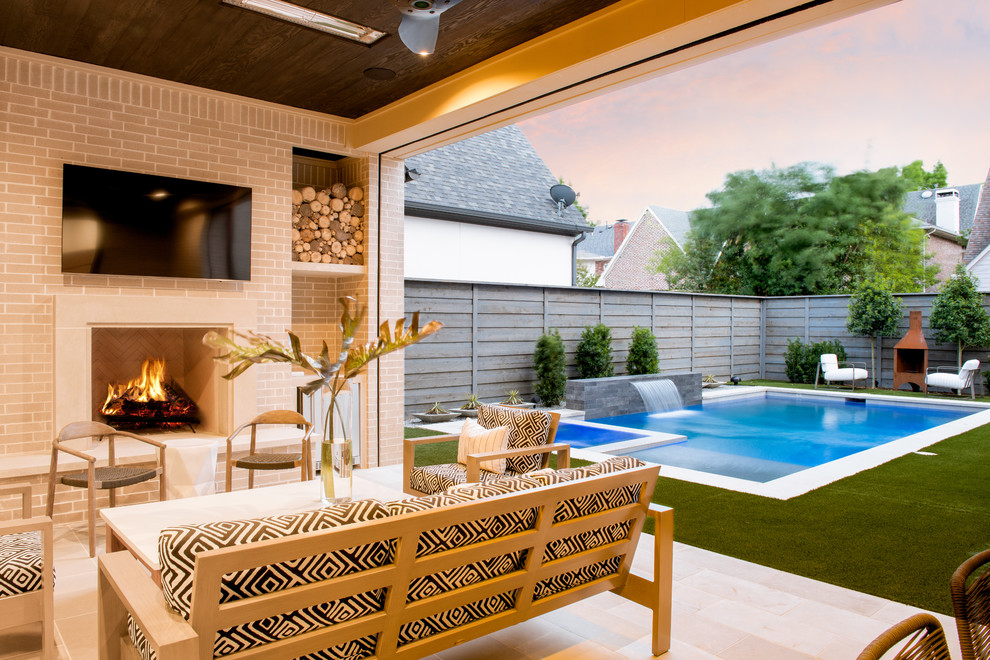 Photo of a contemporary patio in Dallas with a fireplace, tiled flooring and a roof extension.
