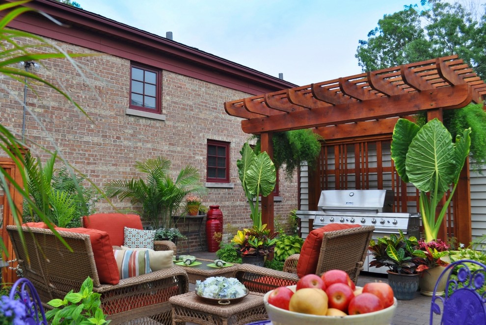 Patio kitchen - small traditional courtyard brick patio kitchen idea in Chicago with a pergola