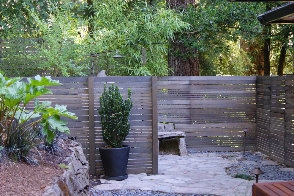 Small contemporary back patio in Portland with an outdoor shower, natural stone paving and no cover.