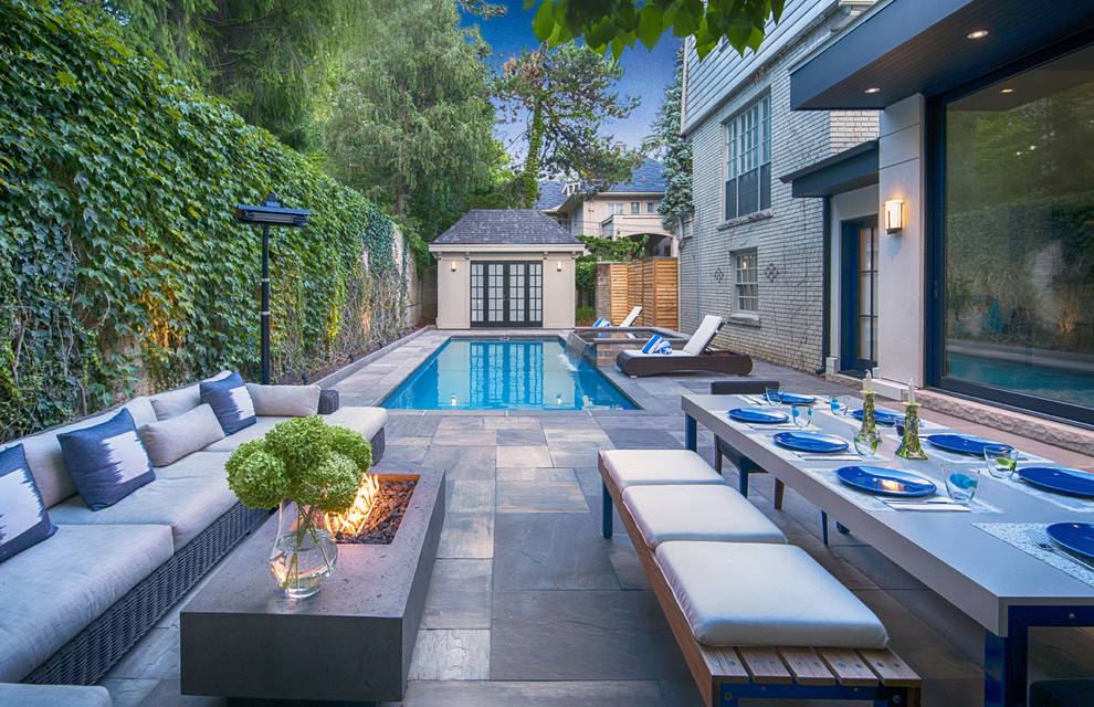 Small transitional backyard stone patio photo in Toronto with a fire pit and no cover