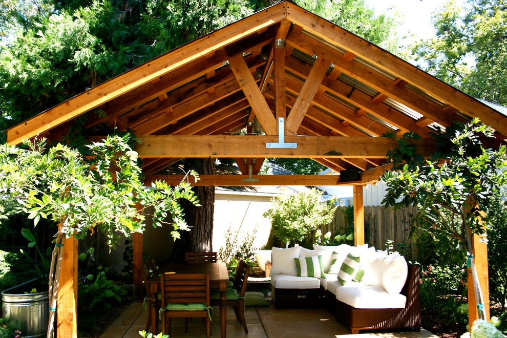 This is an example of a small urban back patio in Sacramento with a gazebo.