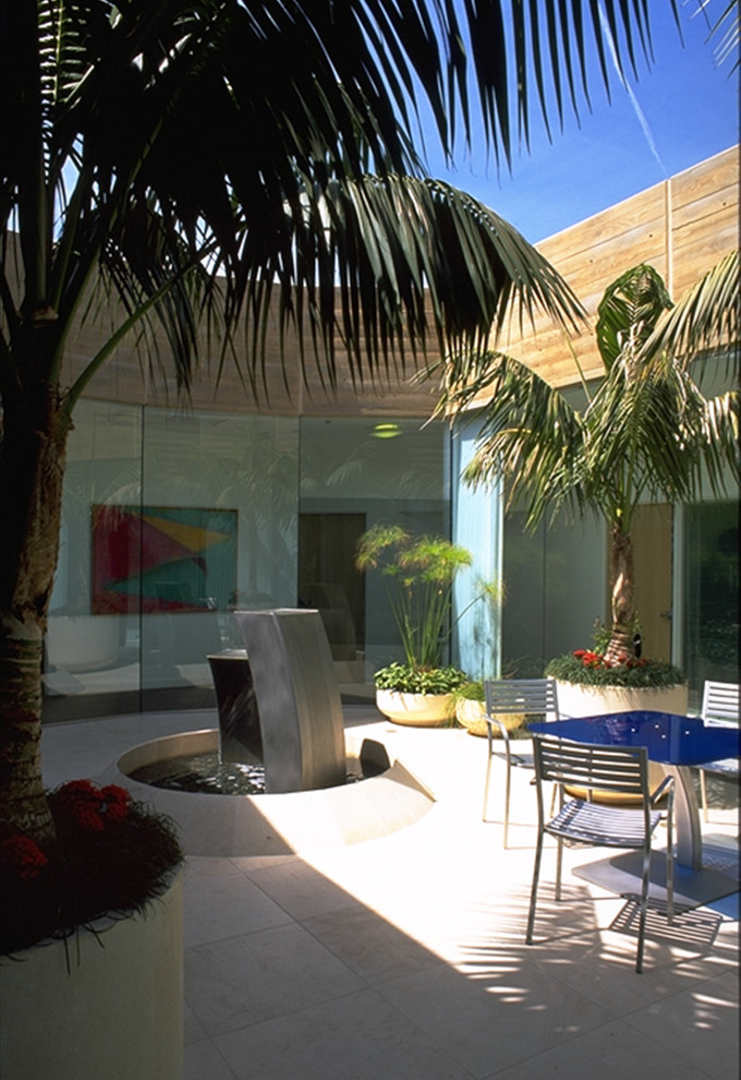 This is an example of a medium sized modern back patio in San Diego with tiled flooring and no cover.
