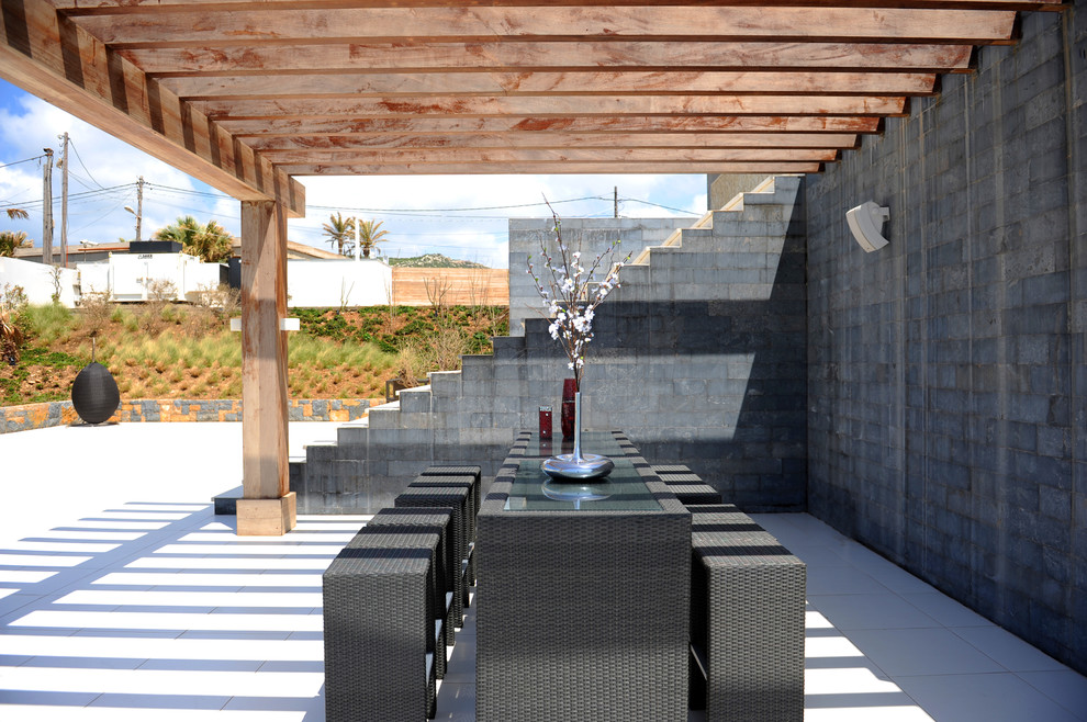 Example of a minimalist patio design in Other with a pergola