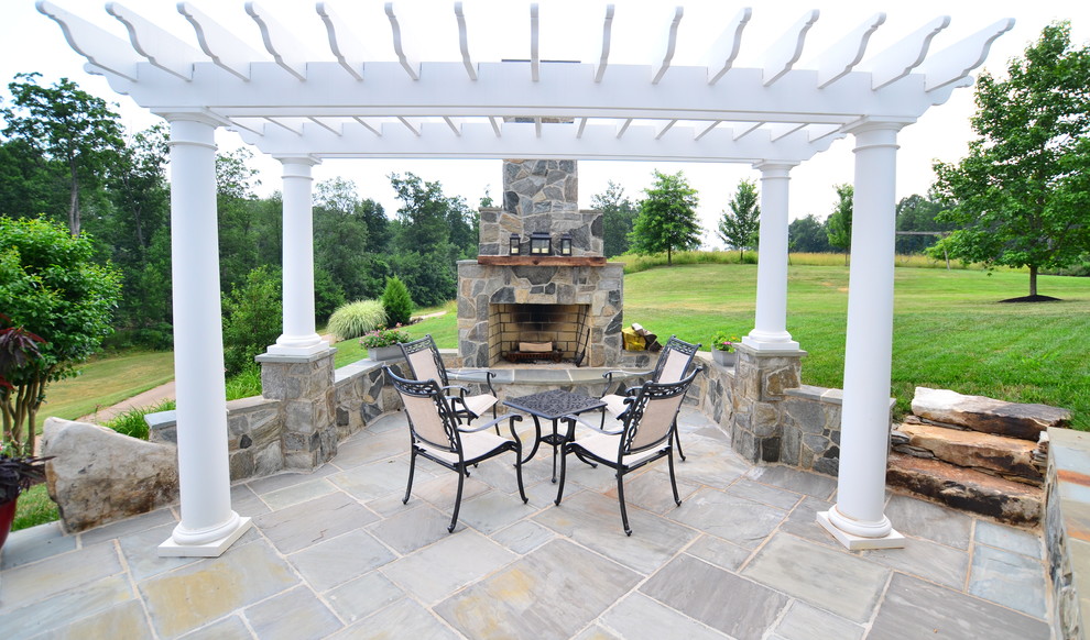 Patio - traditional stone patio idea in DC Metro with a fire pit and a pergola