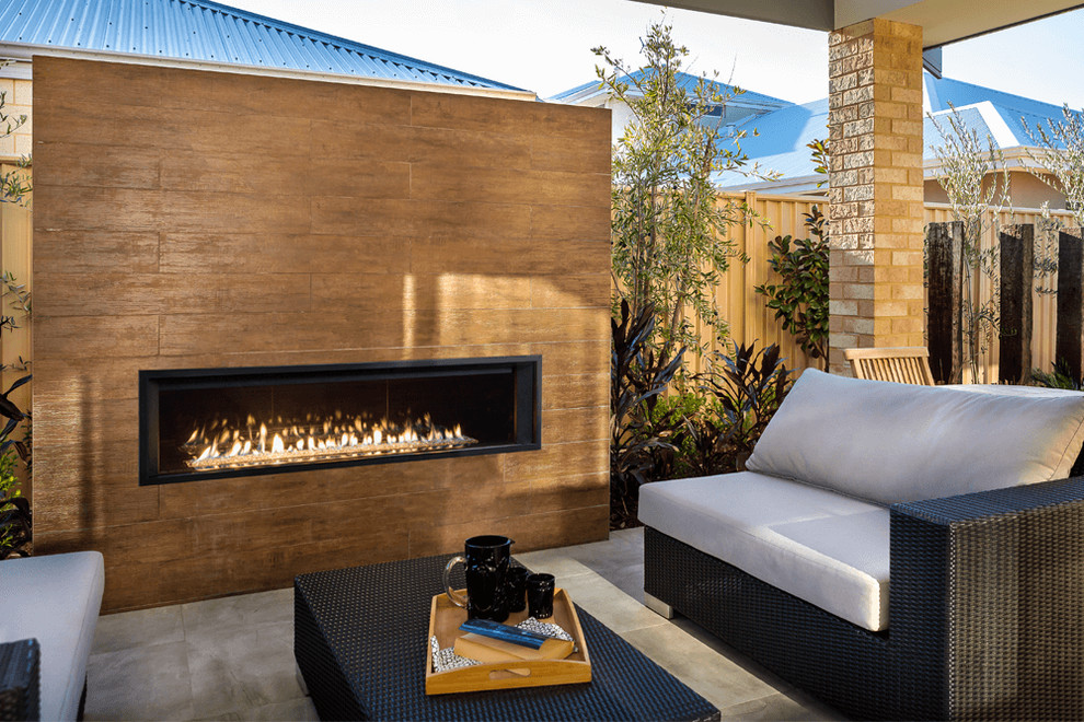 Large trendy backyard tile patio photo in Boston with a fire pit and a roof extension
