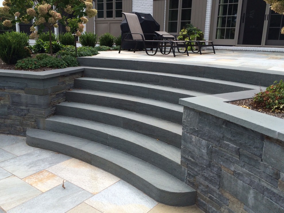 Example of a large classic backyard stone patio container garden design in New York