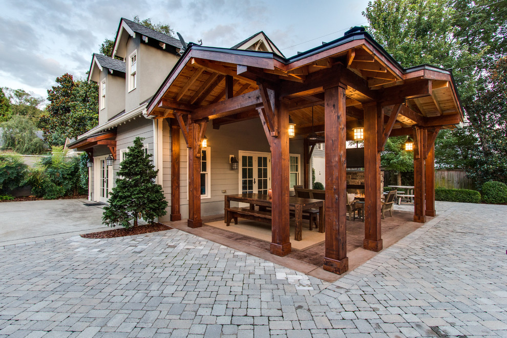 Inspiration for a large rustic back patio in Nashville with a fire feature, brick paving and a pergola.