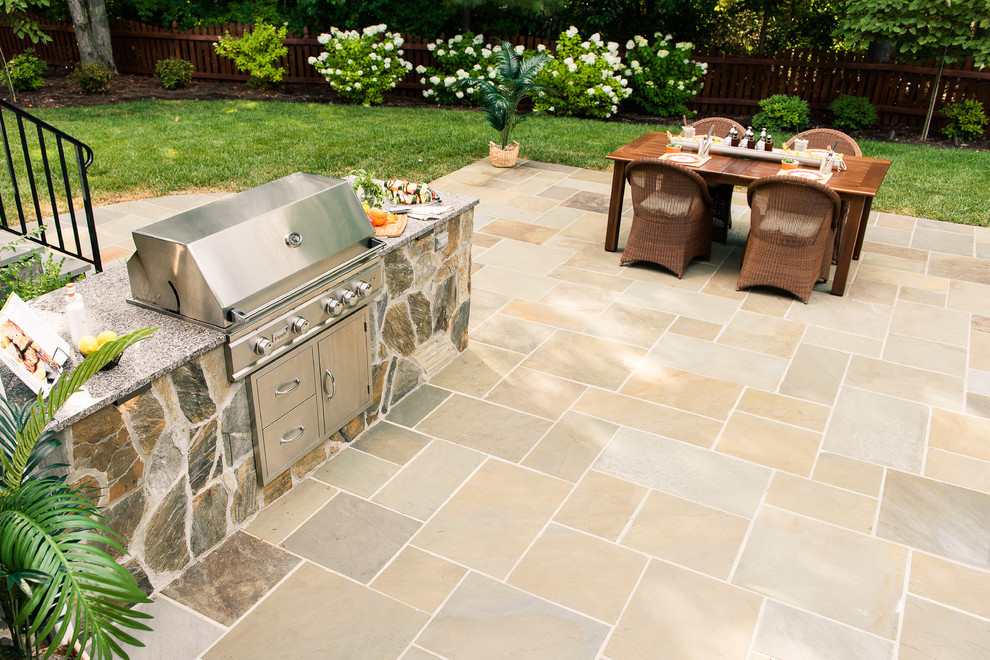 Inspiration for a medium sized traditional back patio in Richmond with an outdoor kitchen, natural stone paving and no cover.
