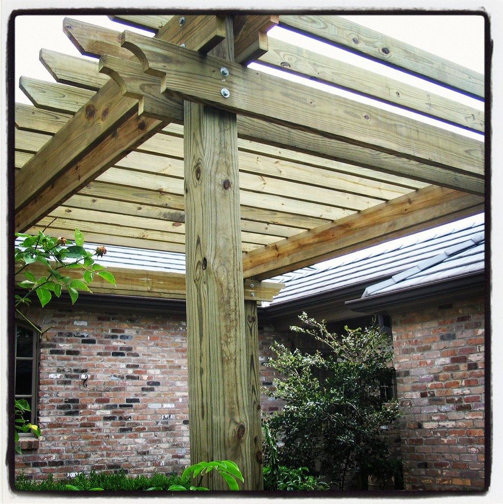 Medium sized classic patio in New Orleans with a pergola.