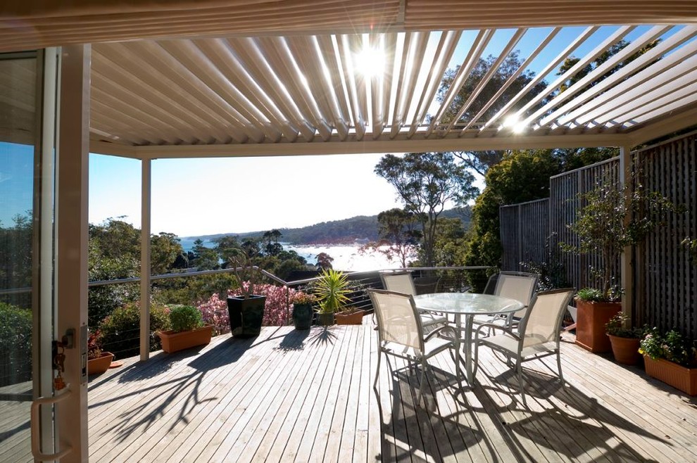 Trendy courtyard patio photo in Sydney with decking and a pergola