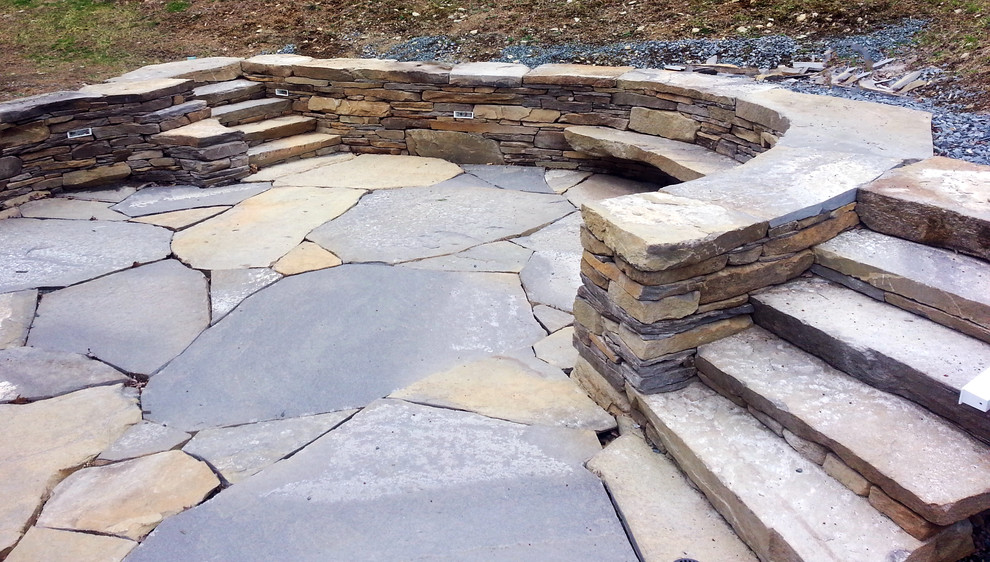 Modelo de patio ecléctico de tamaño medio sin cubierta en patio trasero con adoquines de piedra natural