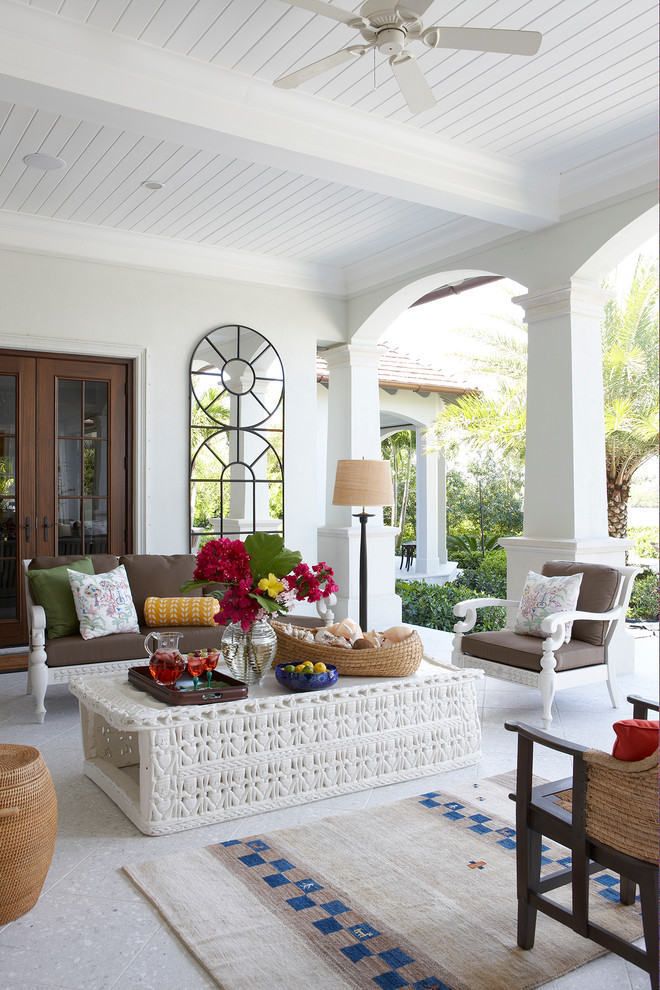 Inspiration for a tropical patio remodel in Miami with a roof extension