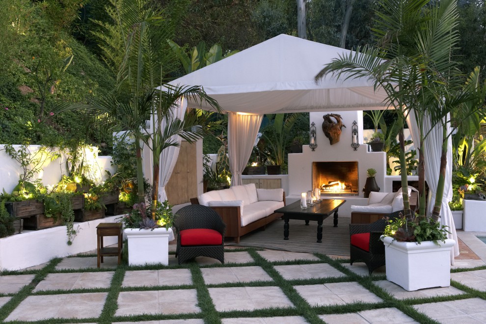This is an example of an eclectic patio in San Diego with a fire feature.