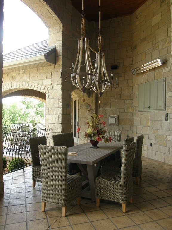 Design ideas for a mediterranean back patio in Other with an outdoor kitchen, tiled flooring and a roof extension.